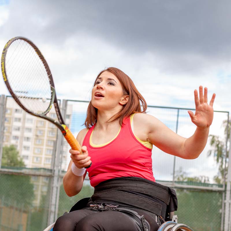 woman playing tennis in wheelchair